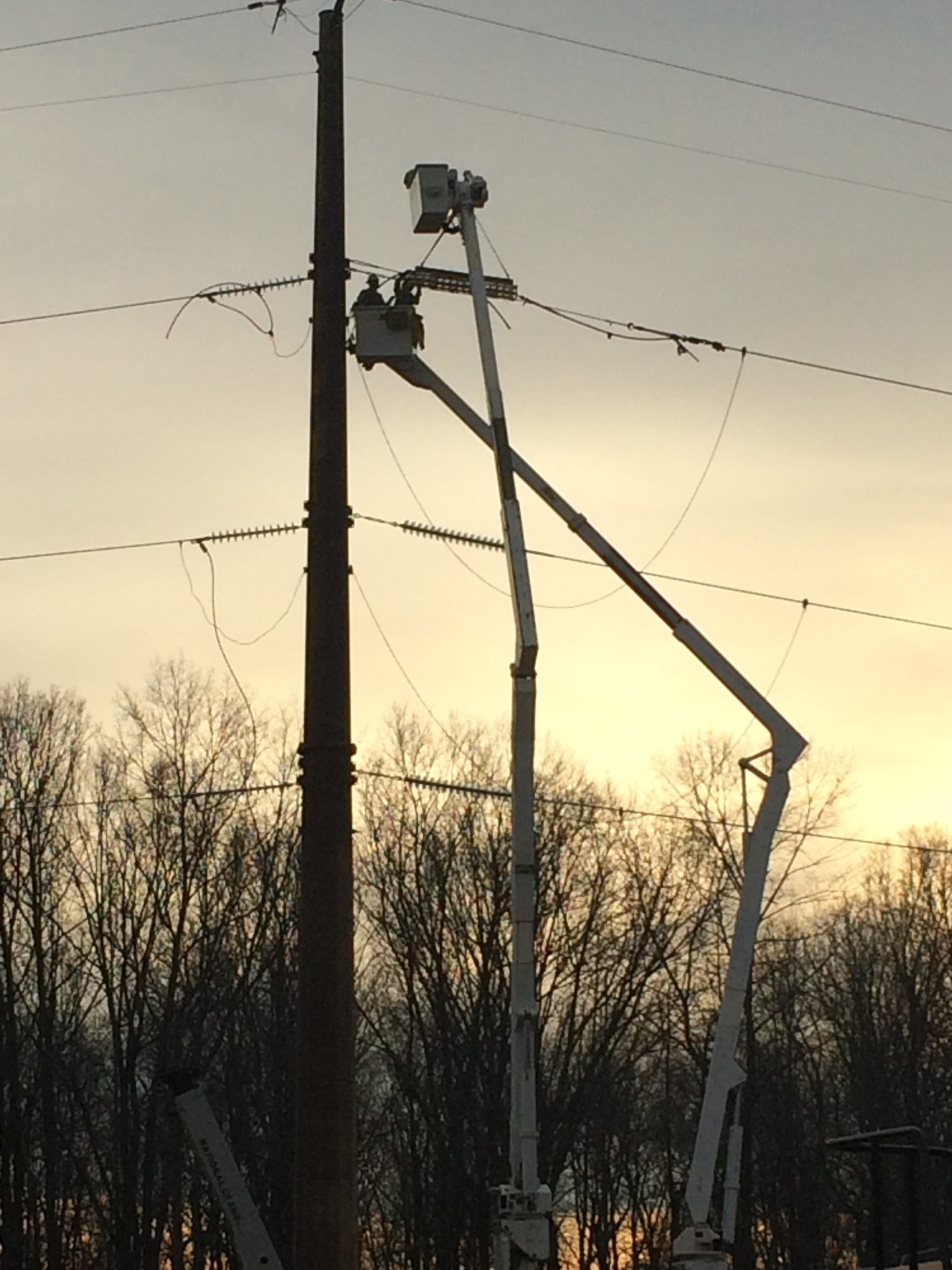 Utility linemen working on power lines
